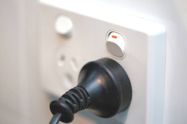 White power point outlet socket (3 pin Australian type) with switch on and black plug inserted